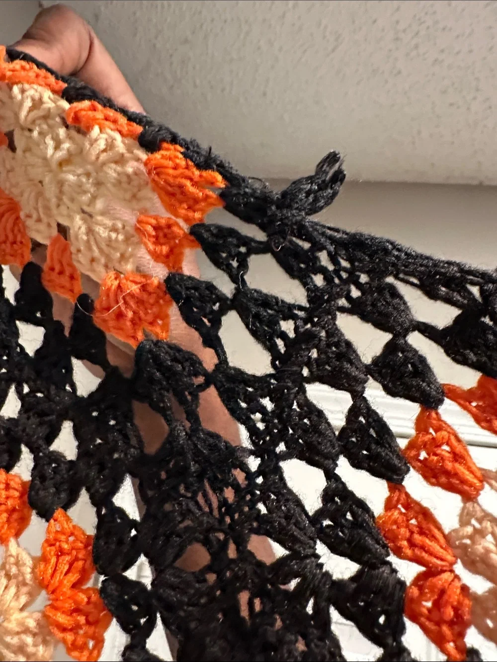 Granny Square black with orange crochet blanket with zig zag hem